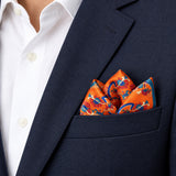 Rust Paisley and Floral pocket square — navy jacket · alternate fold.