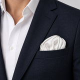 Pearl White Paradigm pocket square — navy jacket · wearing detail.