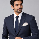 Pearl White Paradigm pocket square — formal model · navy and tie.
