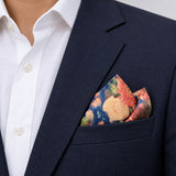 Sapphire Bouquet pocket square — navy jacket · alternate fold.