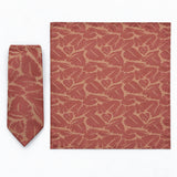 Terracotta Leaf Silhouette silk tie and matching pocket square — Full square · overhead pair