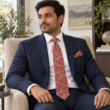 Terracotta Leaf Silhouette silk tie and matching pocket square — Navy suit · seated lifestyle