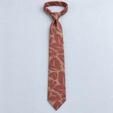 Terracotta Leaf Silhouette Silk Tie — Relaxed knotted layout