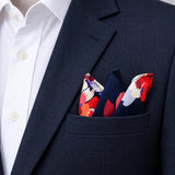 The Deep Blue Floral pocket square — navy jacket · alternate fold.