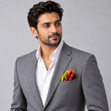 The Mighty Blue Jungle pocket square — model · light grey and open collar.
